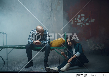 Maniac kidnapper and victim handcuffed to the bed Maniac kidnapper and victim handcuffed to the bed 62203249