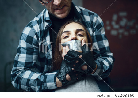 Maniac kidnapper tormenting his scared victim 62203260