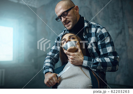 Maniac kidnapper scares his victim with a knife 62203263
