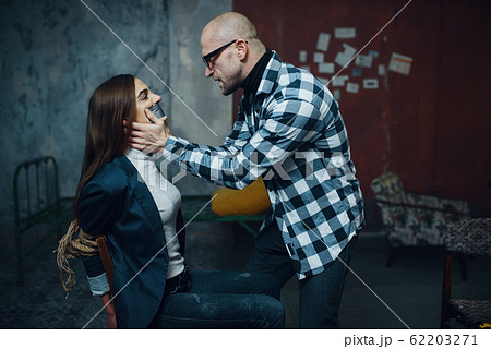 Maniac kidnapper taping his victim's mouth shut 62203271