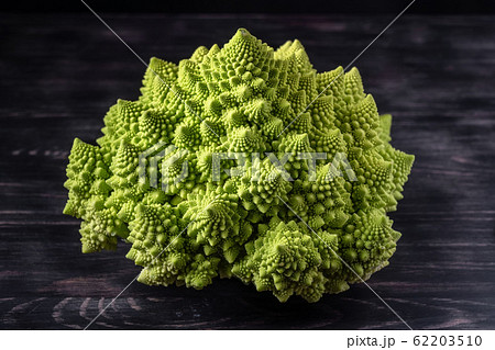 Romanesco broccoli on a dark wooden background. For vegans and a healthy diet. Copy space Romanesco broccoli on a dark wooden background. For vegans and a healthy diet. Copy space 62203510