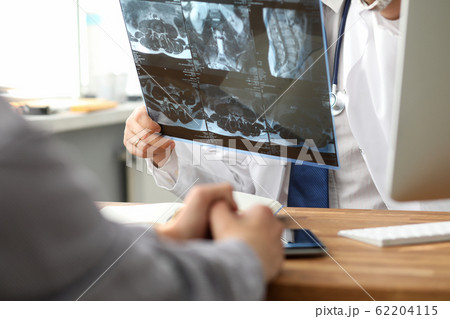Health screening, doctor is looking at MRI data. Health screening, doctor is looking at MRI data. 62204115