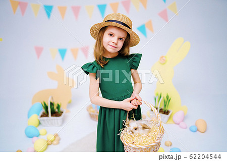the girl with the rabbit. happy little girl holding cute fluffy Bunny. Friendship with Easter Bunny. Spring photo with beautiful young girl with her Bunny. Girl is holding a cute little rabbit 62204544