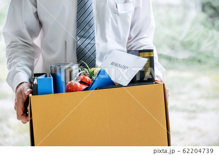 Images of businessman carrying packing up all his 62204739