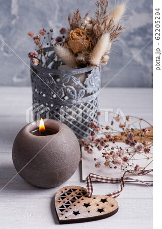 lit candle and wooden heart lit candle and wooden heart 62205294