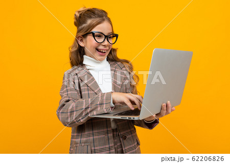 caucasian girl in a business suit with a laptop in hands 62206826