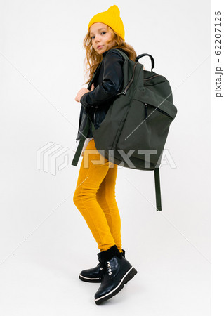 stylish teenager girl in a white shirt, unbuttoned leather black jacket, yellow trousers and a stylish teenager girl in a white shirt, unbuttoned leather black jacket, yellow trousers and a 62207126