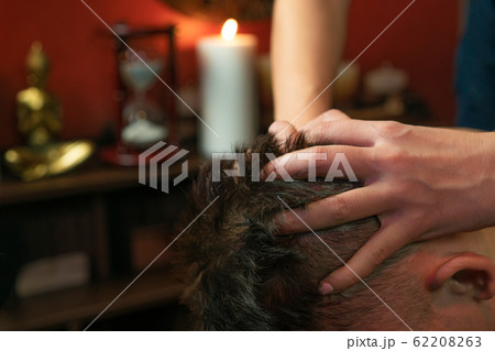 Thai woman gives a man a head massage 62208263