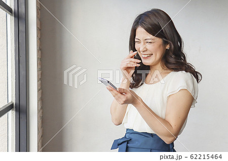 スマホを見て笑う女性 スマホを見て笑う女性 62215464