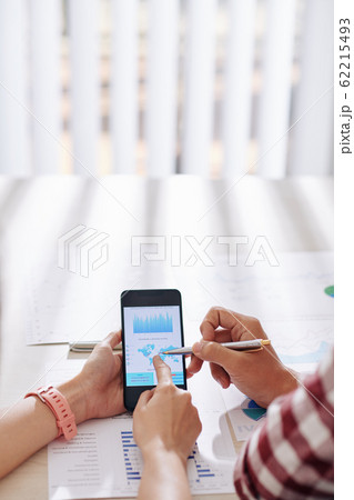 Business people pointing at smartphone screen Business people pointing at smartphone screen 62215493