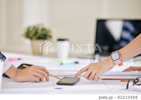Business people pointing at smartphone 62215569