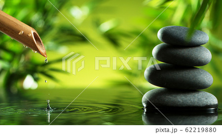 A stream of water flowing out of bamboo tube 62219880