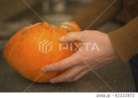 A man holds a mouldy pumpkin. A man holds a mouldy pumpkin. 62222872