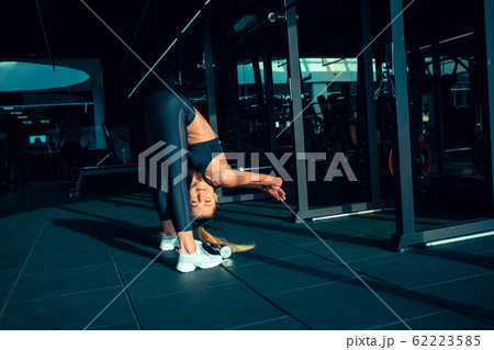 The female athlete training hard in the gym. Fitness and healthy life concept. 62223585