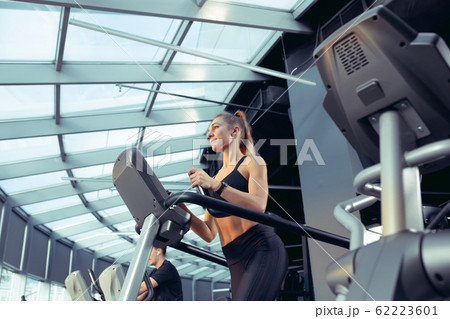 The female athlete training hard in the gym. Fitness and healthy life concept. 62223601