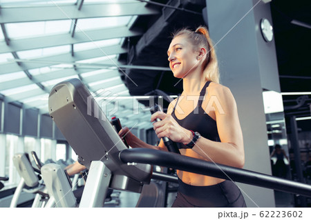 The female athlete training hard in the gym. Fitness and healthy life concept. 62223602