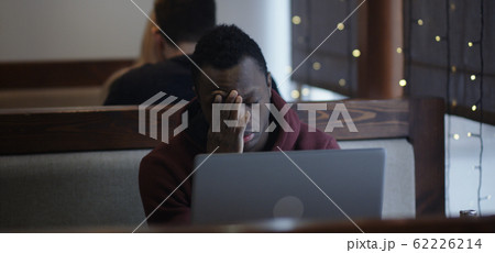 Young man reading bad news 62226214