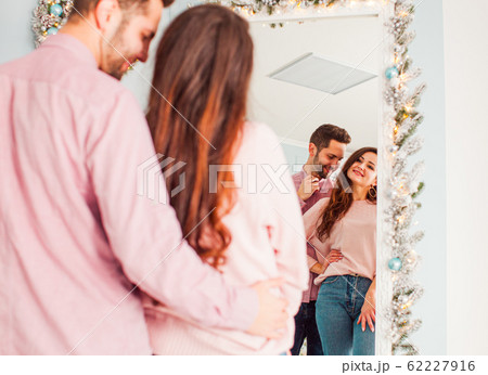 Portrait of young man near large mirror 62227916