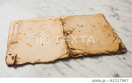 Opened vintage book on marble table with blank pages Opened vintage book on marble table with blank pages 62227967