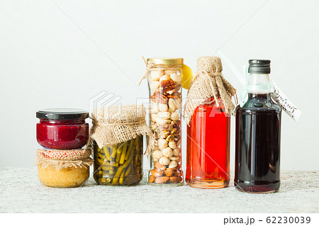 Homemade sauce, seasoning and berry syrup on white table. 62230039