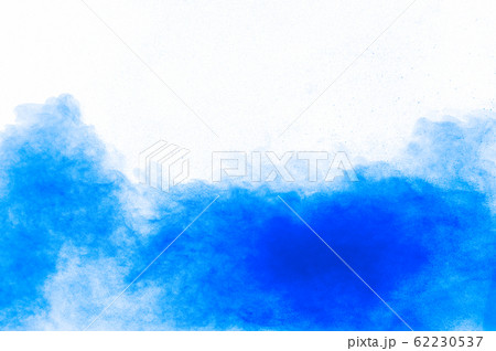 Blue color powder explosion cloud on white background.Closeup of Blue dust particles splash on background. 62230537
