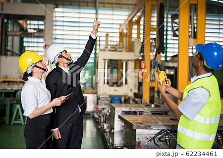 Factory manager command lifting crane in warehouse Factory manager command lifting crane in warehouse 62234461