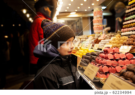 Boy stand near sweet stand with chocolate candies 62234994