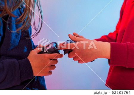 Children using a gaming gadget for virtual reality 62235764
