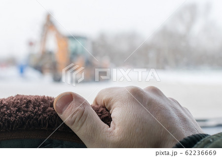 driver hand on the steering wheel of a car 62236669
