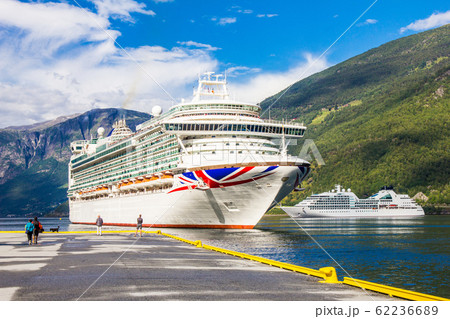 Luxury cruise ship departure in the port of Flam to Stavanger, in sunny summer day, Flam Norway. 25 July 2017. Luxury cruise ship departure in the port of Flam to Stavanger, in sunny summer day, Flam Norway. 25 July 2017. 62236689