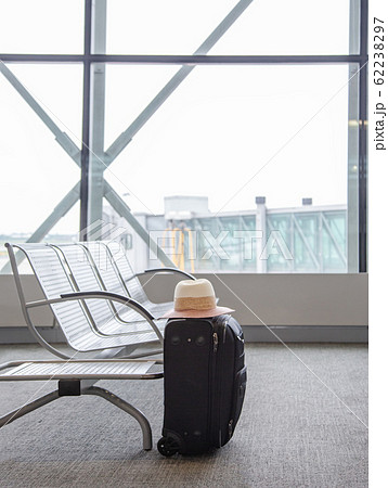 Suitcase in an airport waiting area, one black Suitcase in an airport waiting area, one black 62238297