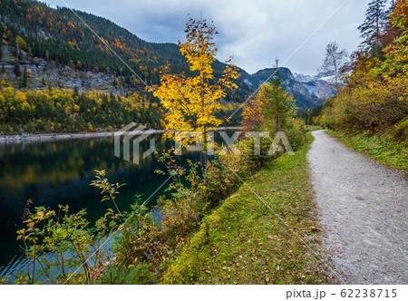 Gosauseen or Vorderer Gosausee lake, Upper Austria. Autumn Alps mountain lake with clear transparent water and reflections. Dachstein summit and glacier in far. 62238715