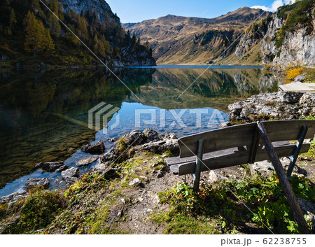 Sunny autumn alpine Tappenkarsee lake and rocky mountains above, Kleinarl, Land Salzburg, Austria. Sunny autumn alpine Tappenkarsee lake and rocky mountains above, Kleinarl, Land Salzburg, Austria. 62238755