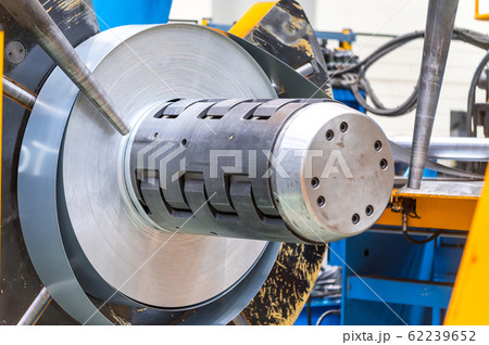 Industrial metal sheet coils connected with metal sheet profile forming machine. Industrial metal sheet coils connected with metal sheet profile forming machine. 62239652