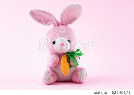 toy pink rabbit on a pastel pink background with a 62240172