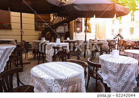 cafe - tables with chairs placed on the street 62242044