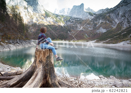 beautiful girl sitting on a stump beautiful girl sitting on a stump 62242821