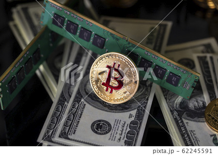 Bitcoins btc bit-coin stand on a black reflective 62245591