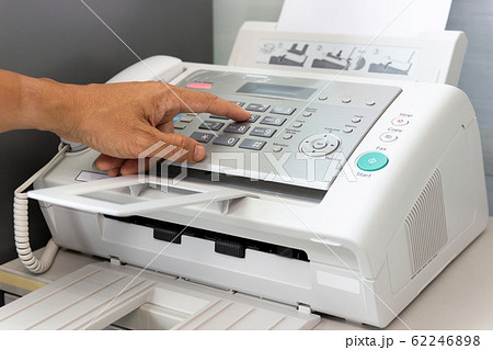 Hand man are using a fax machine in the office 62246898