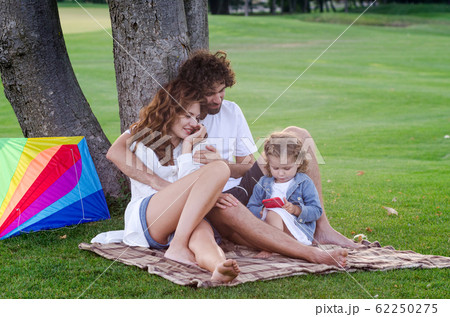 Happy young family in the park Happy young family in the park 62250275