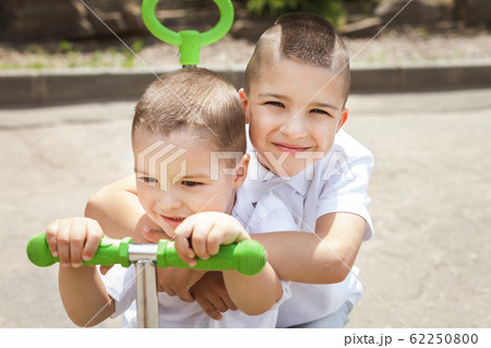 boy with brother on a trike boy with brother on a trike 62250800