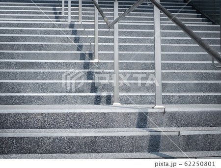 Empty gray stone ladder with stainless steel handrail with sunlight. Empty gray stone ladder with stainless steel handrail with sunlight. 62250801
