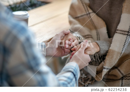 Male hands and female hands holding each other. Male hands and female hands holding each other. 62254238