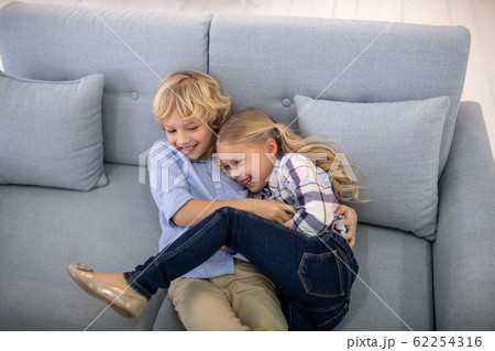 Boy and girl giggling, tickling each other 62254316