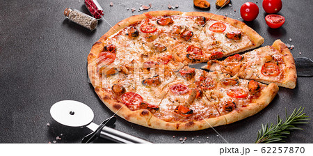 Tasty sliced pizza with seafood and tomato 62257870