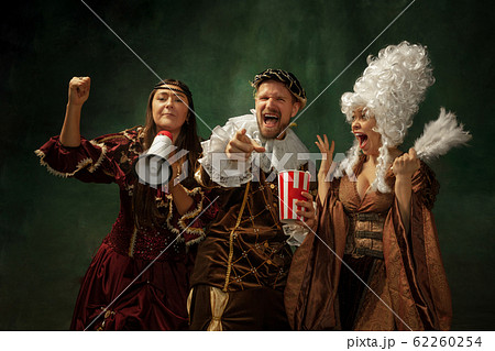 Medieval young man and women in old-fashioned costume 62260254