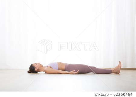 Portrait of gorgeous active sporty young woman practicing breathing exercises in yoga studio. Healthy active lifestyle, working out indoors in gym Portrait of gorgeous active sporty young woman practicing breathing exercises in yoga studio. Healthy active lifestyle, working out indoors in gym 62260464