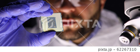 Worker making diagnostics of chip Worker making diagnostics of chip 62267310