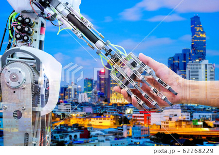 AI Robot handshake with human for join on teamwork on blurred building construction on blue tone color background, industry 4.0 and business construction concept, double exposure image AI Robot handshake with human for join on teamwork on blurred building construction on blue tone color background, industry 4.0 and business construction concept, double exposure image 62268229
