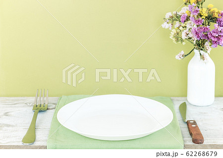 Empty plate on tablecloth or napkin on wooden 62268679